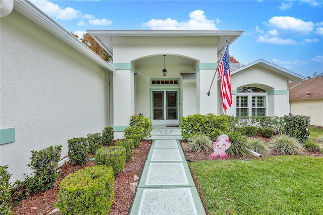 property entrance featuring a lawn