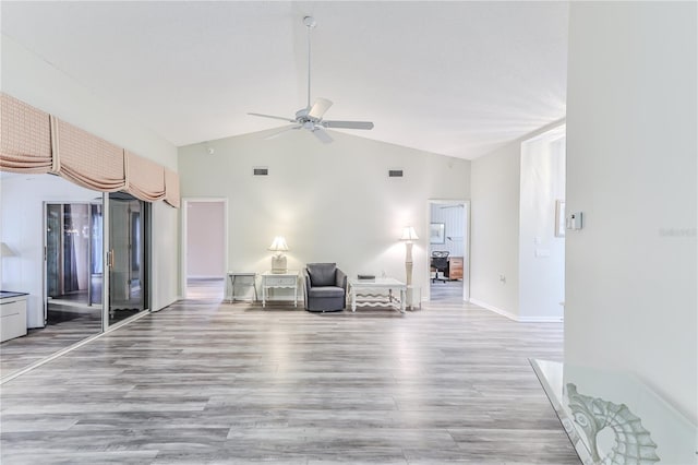 unfurnished room with vaulted ceiling, ceiling fan, and light hardwood / wood-style flooring