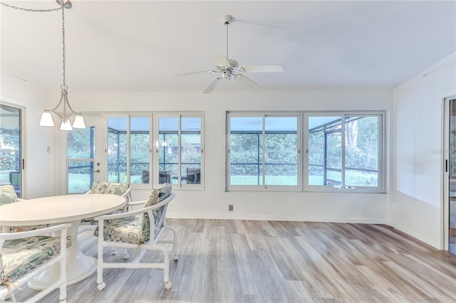 unfurnished sunroom featuring ceiling fan