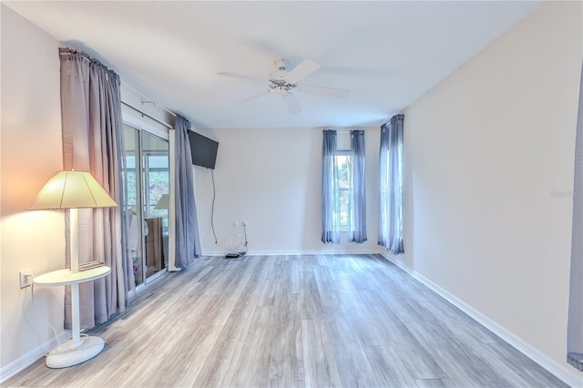 unfurnished room with ceiling fan, light hardwood / wood-style flooring, and plenty of natural light