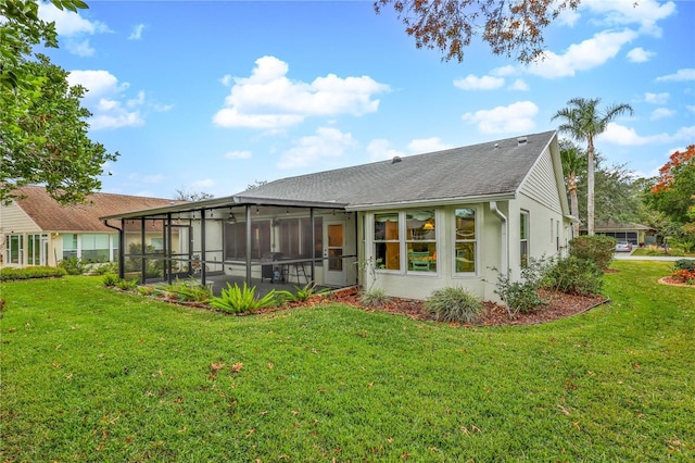 rear view of property with a yard