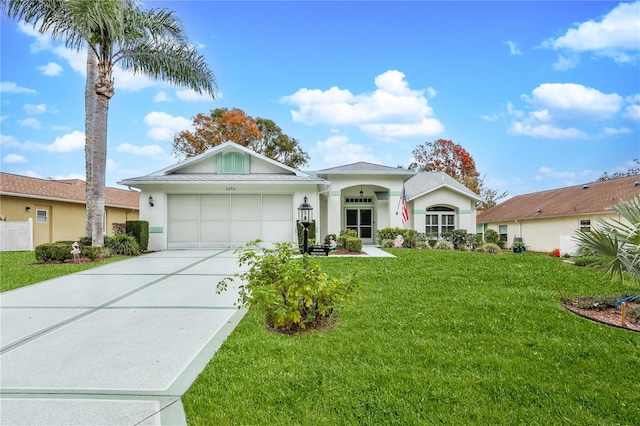 ranch-style home featuring a garage and a front lawn