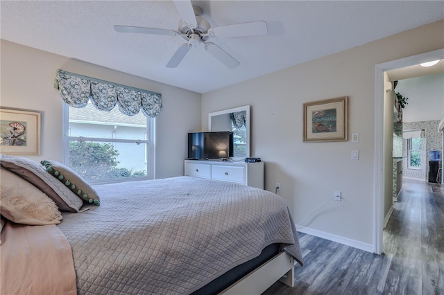 bedroom featuring ceiling fan and dark hardwood / wood-style floors