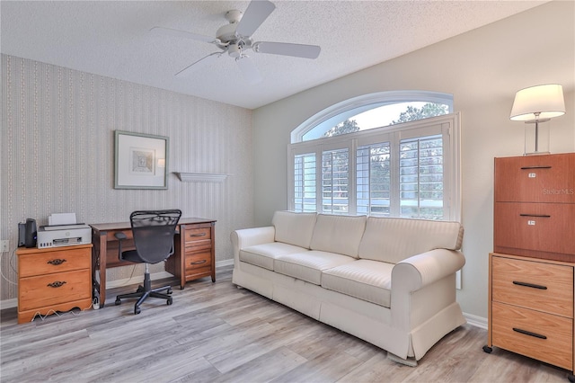 office area featuring ceiling fan, a textured ceiling, and light hardwood / wood-style flooring