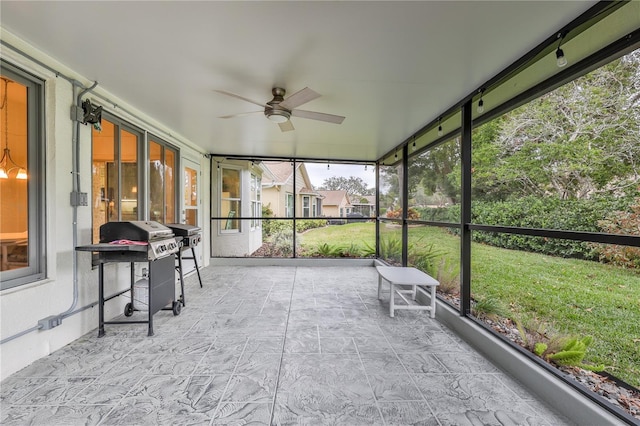 sunroom with ceiling fan and a wealth of natural light