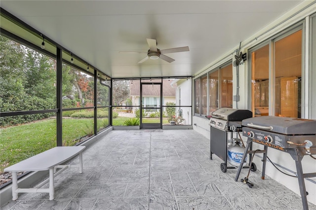 unfurnished sunroom with ceiling fan and a healthy amount of sunlight