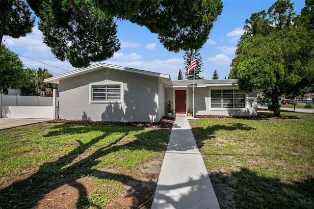 ranch-style house with a front lawn