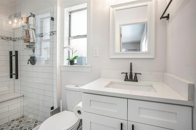 bathroom featuring toilet, an enclosed shower, and vanity