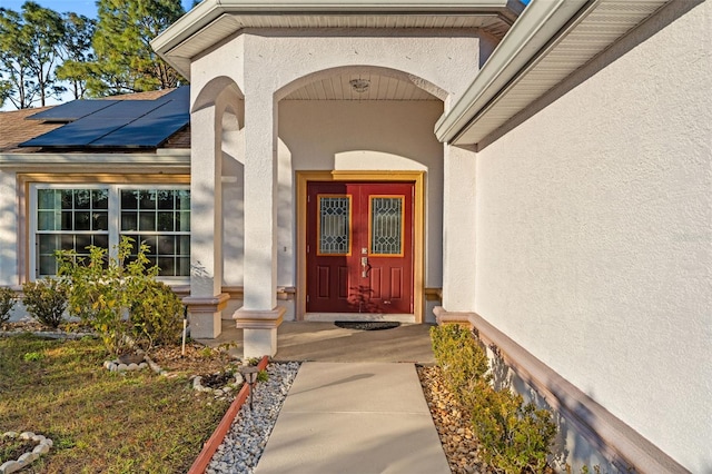 doorway to property with solar panels