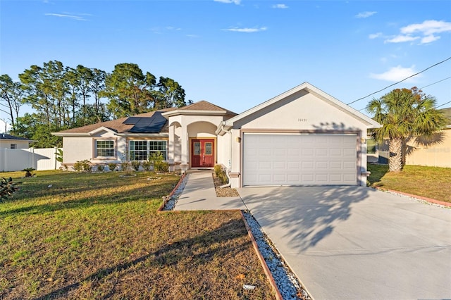 view of front of home with solar panels, a front yard, and a garage