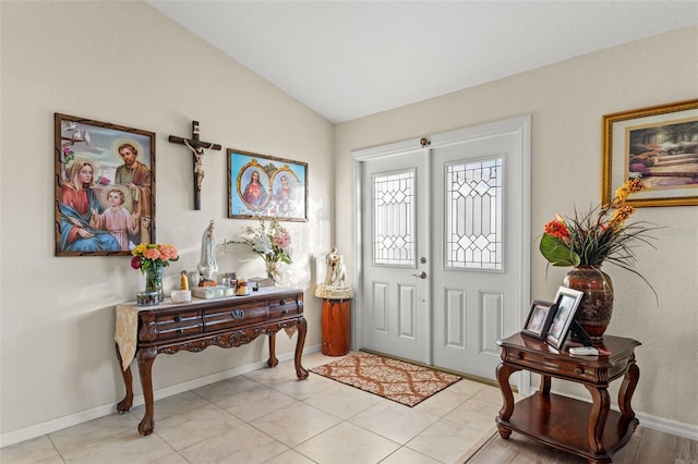 entryway featuring lofted ceiling and light tile patterned floors