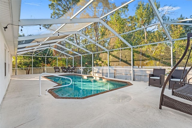 view of swimming pool with glass enclosure and a patio area