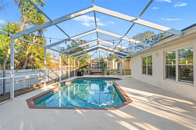 view of swimming pool with a lanai and a patio area