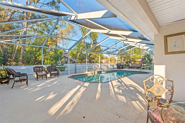 view of swimming pool with a lanai and a patio