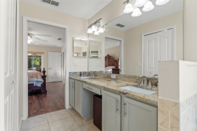 bathroom with tile patterned flooring, ceiling fan, and vanity