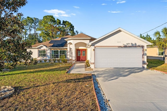 view of front of house with french doors, solar panels, and a front yard