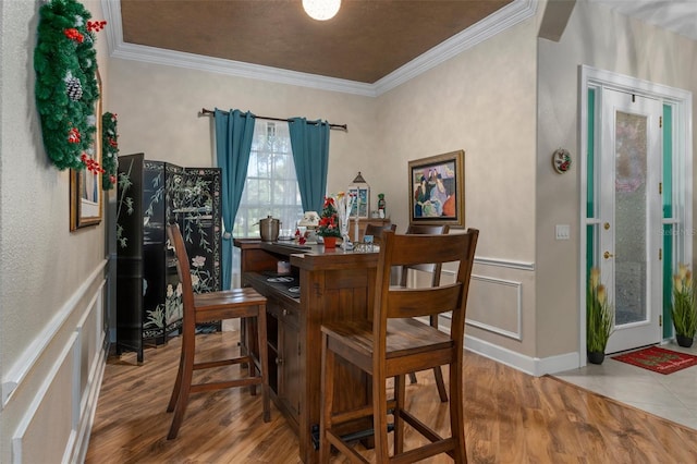 interior space featuring wood-type flooring and crown molding