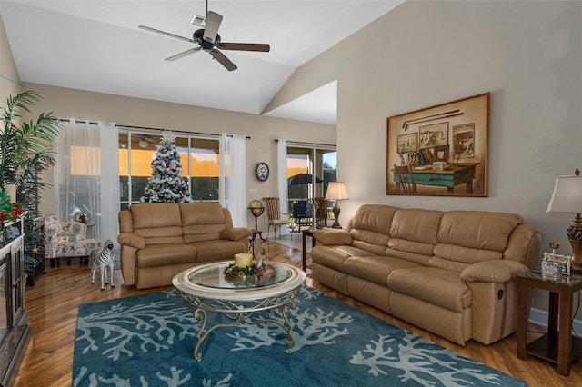 living room featuring ceiling fan, vaulted ceiling, and hardwood / wood-style flooring