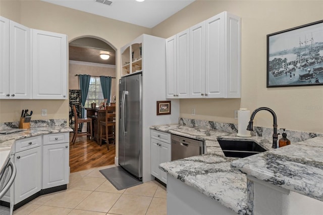 kitchen with sink, white cabinets, and appliances with stainless steel finishes