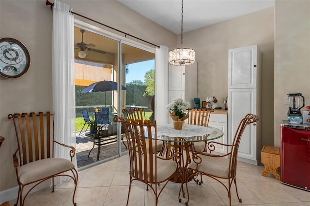 tiled dining space with ceiling fan