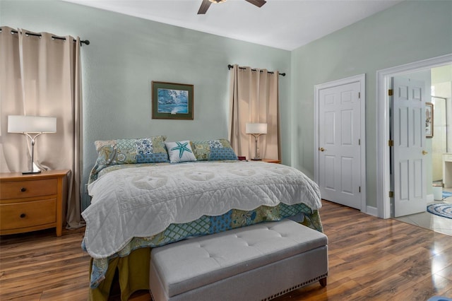 bedroom with ceiling fan, connected bathroom, and dark hardwood / wood-style floors