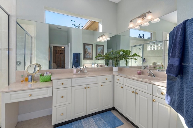 bathroom with an enclosed shower, vanity, tile patterned floors, and a wealth of natural light