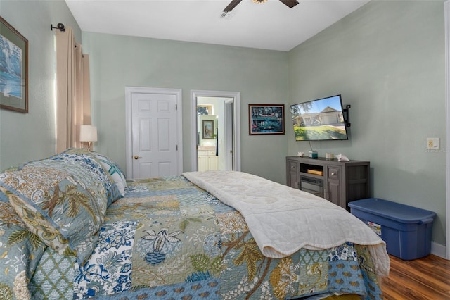 bedroom with ceiling fan, dark wood-type flooring, and ensuite bathroom