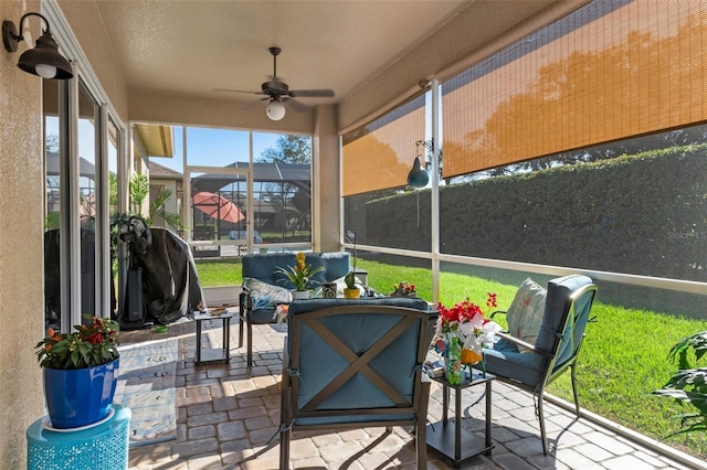 sunroom with ceiling fan and a healthy amount of sunlight