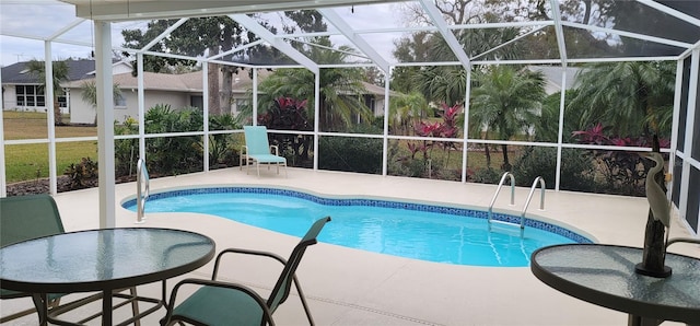 view of swimming pool with a lanai and a patio