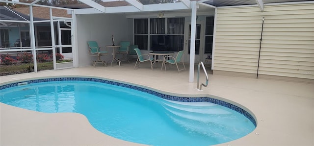 view of swimming pool with a lanai and a patio