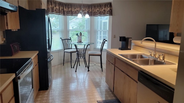 kitchen featuring sink, decorative light fixtures, exhaust hood, a chandelier, and appliances with stainless steel finishes