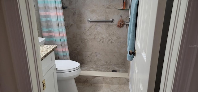 bathroom featuring curtained shower, vanity, and toilet