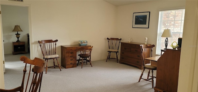 living area featuring light carpet