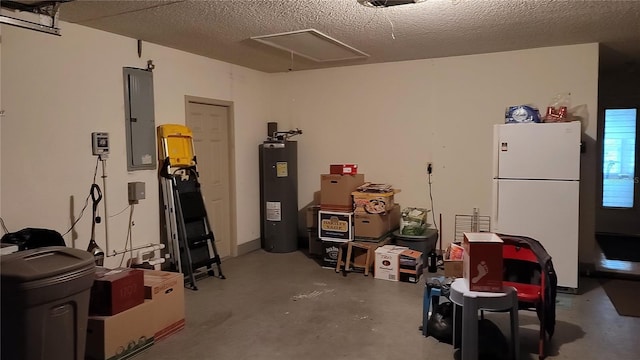 garage featuring white refrigerator, water heater, and electric panel