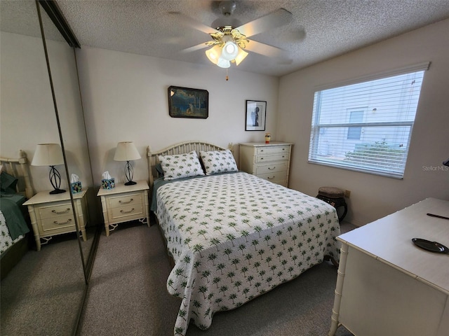 carpeted bedroom with a textured ceiling and ceiling fan