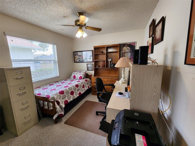 carpeted bedroom with a textured ceiling and ceiling fan