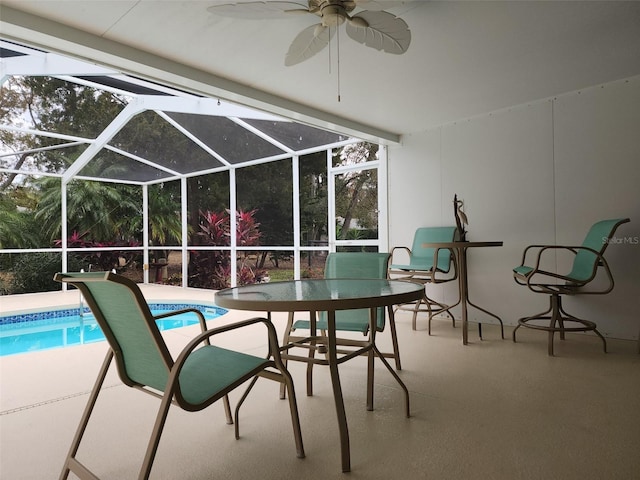 view of swimming pool featuring ceiling fan, a patio, and glass enclosure