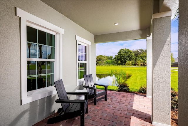 view of patio with a water view