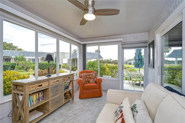 sunroom / solarium featuring ceiling fan