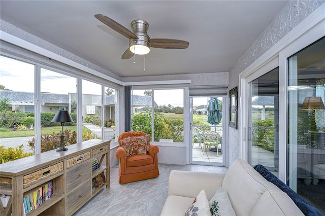 sunroom / solarium featuring ceiling fan