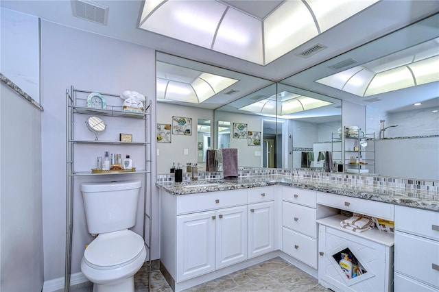 bathroom with toilet, a shower, and vanity