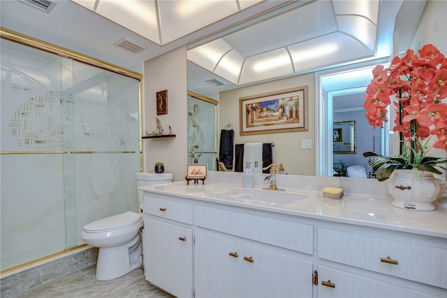 bathroom featuring toilet, a shower with door, and vanity