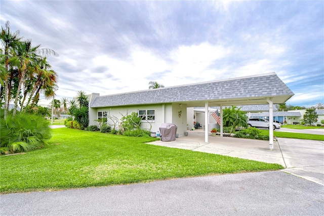 exterior space with a front yard and a carport