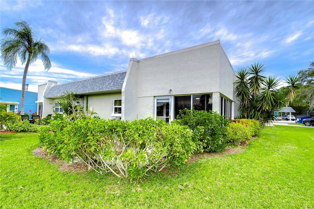 view of home's exterior with a lawn