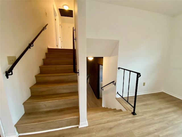 stairway featuring wood-type flooring