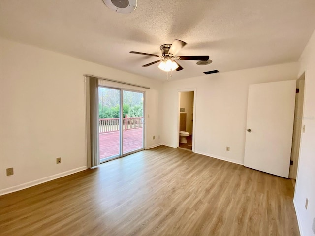 unfurnished room with ceiling fan, light hardwood / wood-style flooring, and a textured ceiling