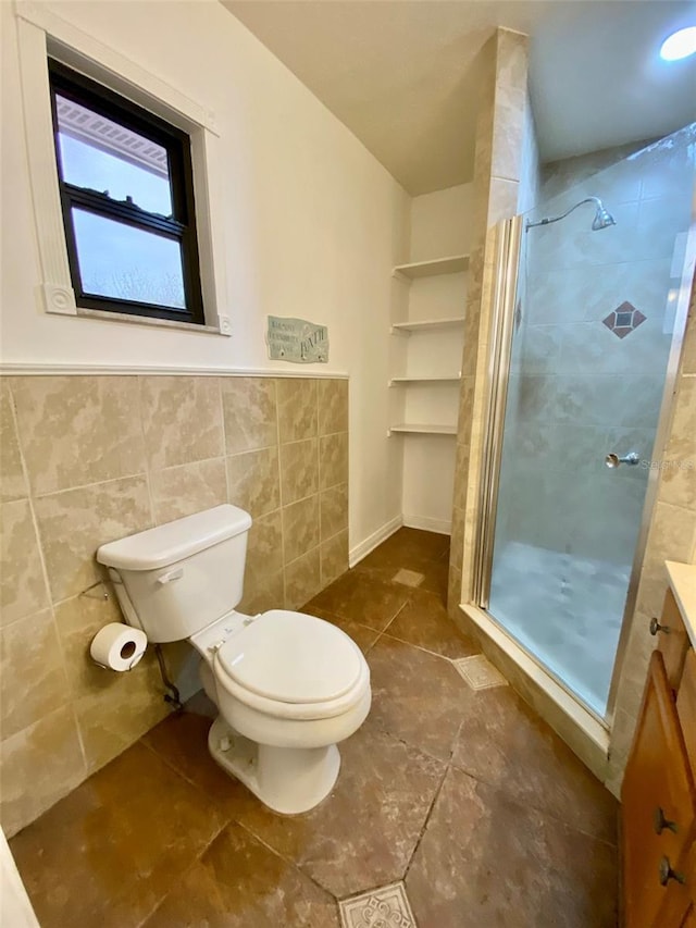 bathroom with tile walls, toilet, walk in shower, and vanity