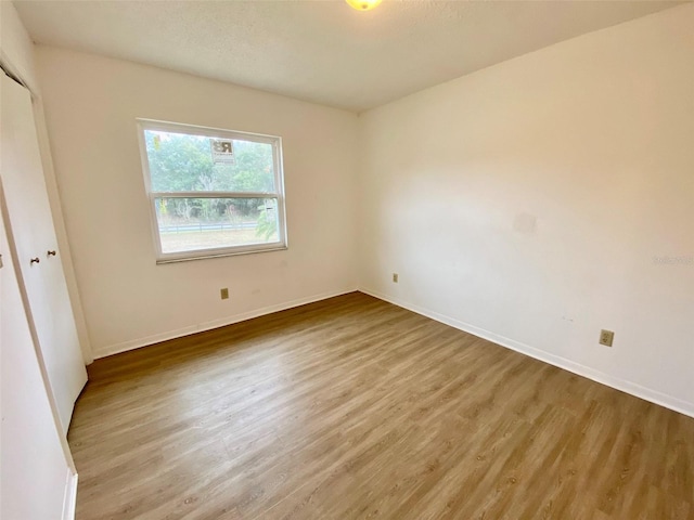 unfurnished bedroom with hardwood / wood-style flooring