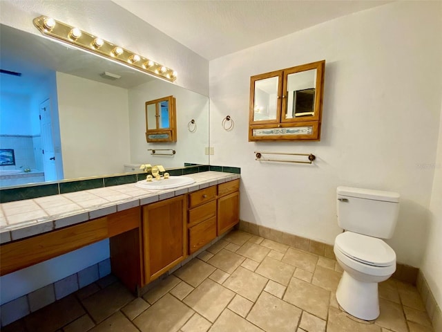 bathroom with toilet and vanity