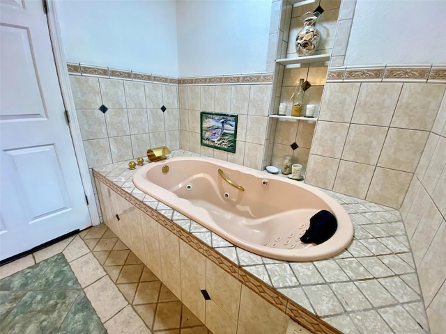 bathroom with tile patterned floors and tiled tub